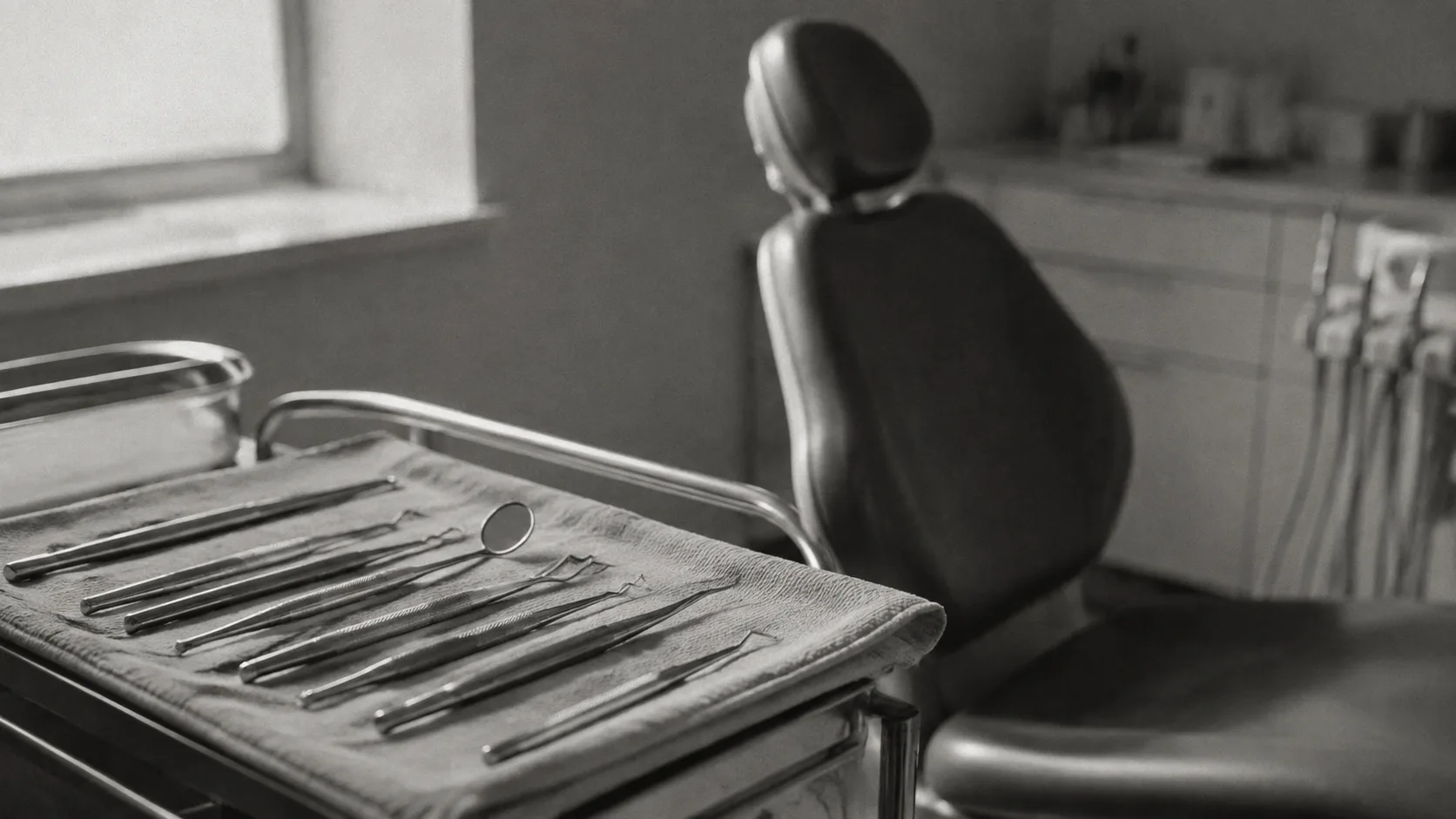 Illustrative arrangement of sterilized instruments beside an empty dental chair.